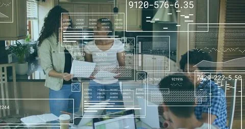 Working four adults analyzing code and papers around kitchen island with laptops 写真素材