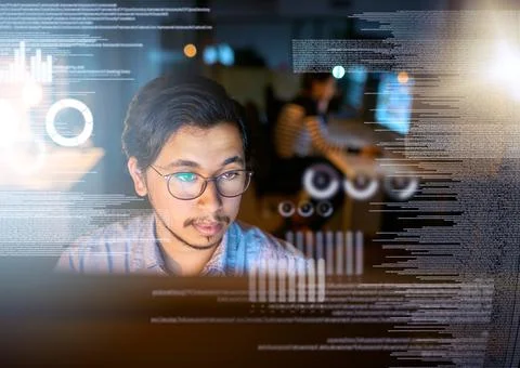 Working on getting these codes cracked. Shot of a computer programmer looking Stock Photos