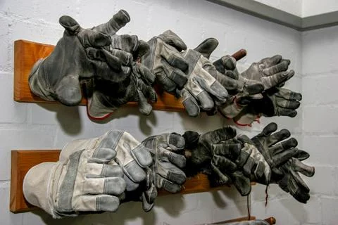 Working gloves at the wall. Stock Photos
