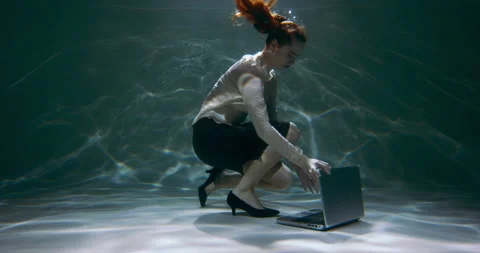 Working on the go. Beautiful young software expert woman dives underwater to Stock Footage 153903597