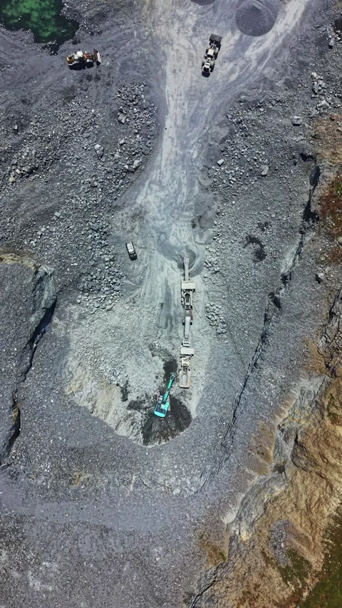 Working at a granite quarry where heavy machinery moves materials and workers Stock Footage 337893618