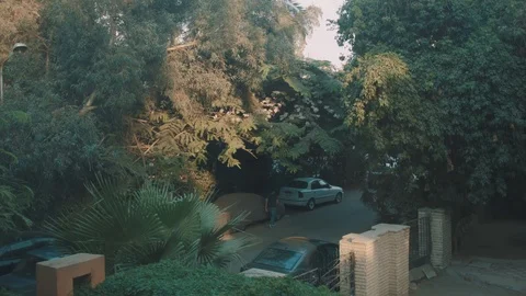 Working green area with trees and parking-lot and villa front Stock Footage