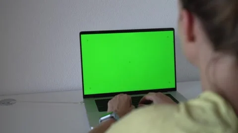 Working on a green screen laptop in a home office setting during the day Stock Footage 340190067