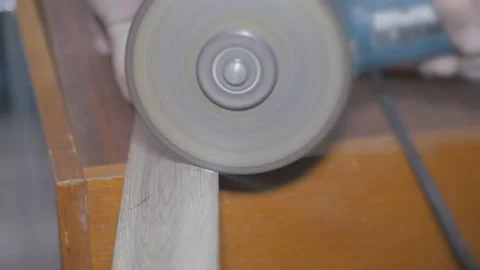 Working as a grinder. Cutting off the floor plastic skirting board with a cable Stock Footage 148228481