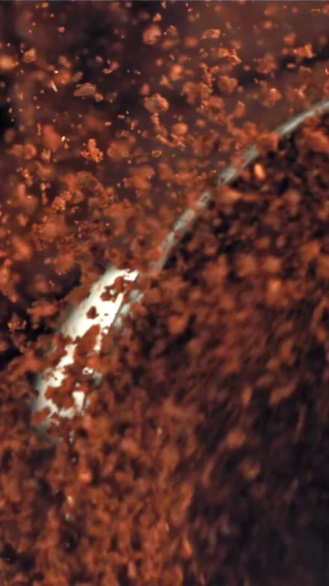 A working grinder with ground coffee. Top view. Filmed on a high-speed camera at Stock Footage 335321778