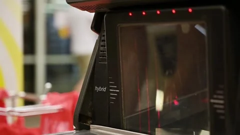 Working on grocery store checkout counter. cashier scanning items on modern 動画素材 334644659
