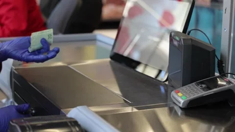 Working on grocery store checkout counter. cashier scanning items on modern Stock Footage 334644662