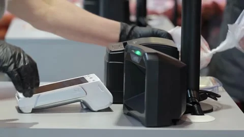 Working on grocery store checkout counter. cashier scanning items on modern Stock Footage 334644712