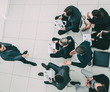 Working group with financial documents sitting in the conference room. Stock Photos