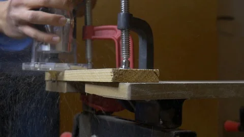 Working With a Hand Router in a Workshop Cutting Wood Woodworking Clamps Stock Footage 114073791