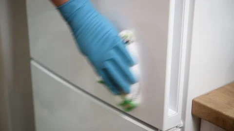 The working hand wipes the refrigerator handle. General or regular cleaning. Video stock 299721353