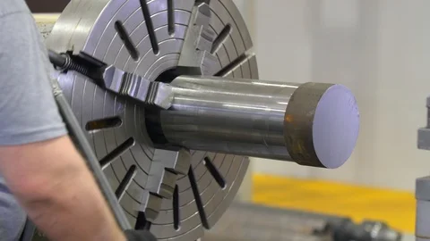 The working hands in gloves fasten the piece in a lathe. The working of metal. Stock Footage 128648714