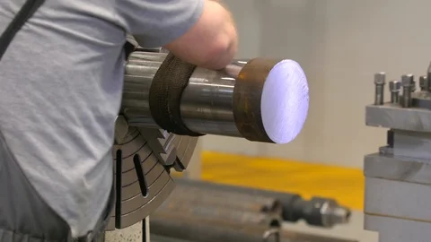The working hands in gloves fasten the piece in a lathe. The working of metal. Video stock 129847893