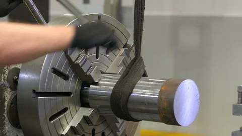 The working hands in gloves fasten the piece in a lathe. The working of metal. Video stock 129847918