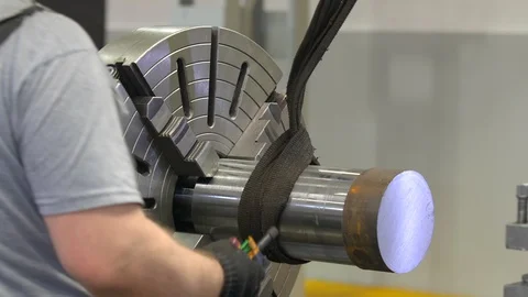The working hands in gloves fasten the piece in a lathe. The working of metal. Stock Footage 129847968