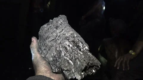Working hands hold coal in the mine Stock-Footage 94116441