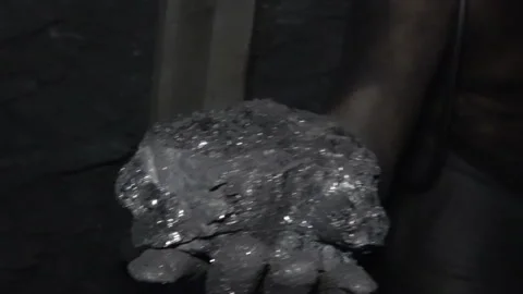 Working hands hold coal in the mine Stock Footage 94117417