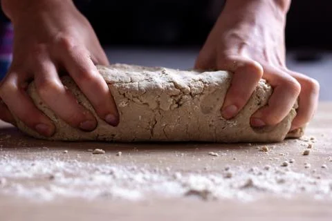 Working hands kneading bread dough Stock Photos