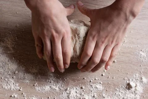 Working hands kneading bread dough. Handmade concept Stock Photos