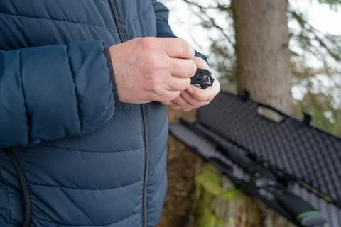 Working hands load bullets into the clip, preparing for target shooting. Hand Stock Photos