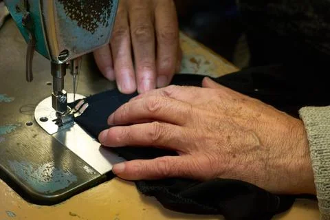 Working hands of a tailor on a sewing machine Stock Photos