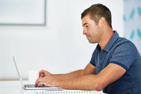 Working hard to acheive success. a young man working on his laptop. Stock Photos