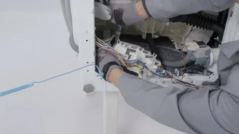 Working hard and fixing a problem on a washing machine Stock Footage 85832700
