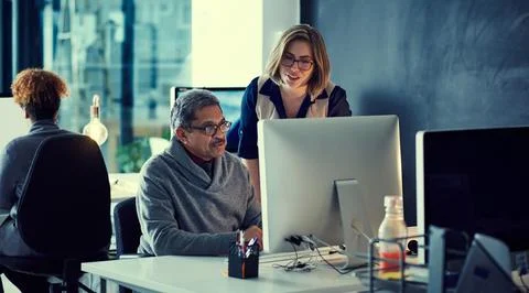 Working hard to maintain their top standards. a group of businesspeople working Stock Photos