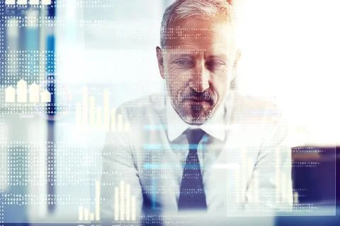 Working on his code. a mature businessman working on programming code. Stock Photos