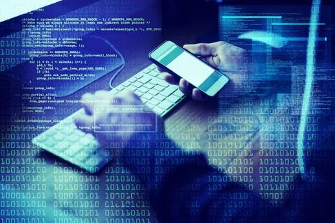 Working his way into your database. an unidentifiable computer hacker using a Fotos de archivo