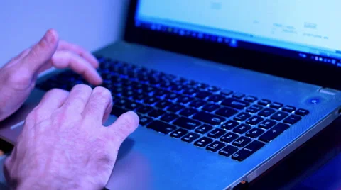 Working from home concept. Man typing text on the laptop keyboard, blue light Stock Footage 64526554