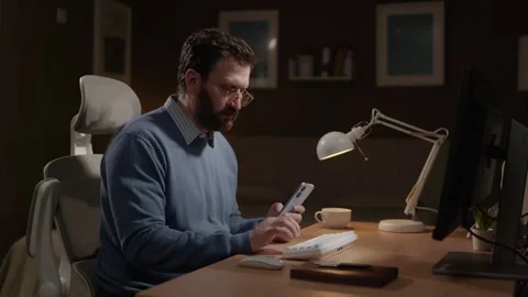 Working from home, freelancer at work concept. Focused man in home office using Stockbeeldmateriaal 337645927