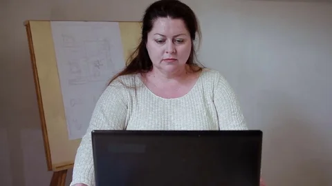 Working at home mom hugging her son and playing with him Stock Footage 76692299