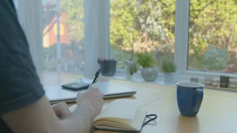 Working from home with a notepad on the dinner table Foto stock