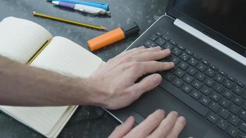 Working from home using a laptop on the dinner table Foto stock