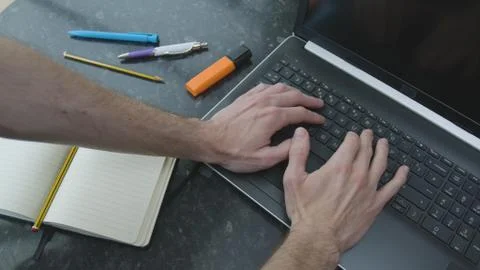 Working from home using a laptop on the dinner table Foto stock