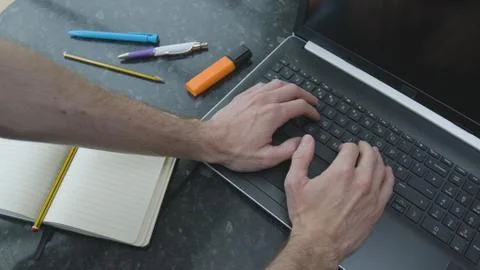 Working from home using a laptop on the dinner table Foto stock