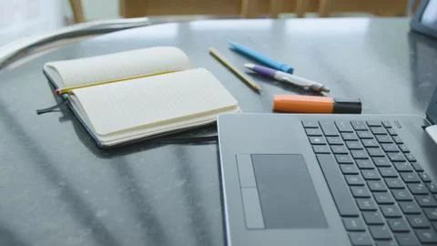 Working from home using a laptop on the dinner table Foto stock