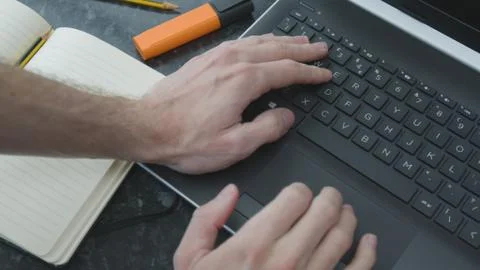 Working from home using a laptop on the dinner table Foto stock