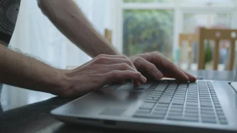 Working from home using a laptop on the dinner table Foto stock