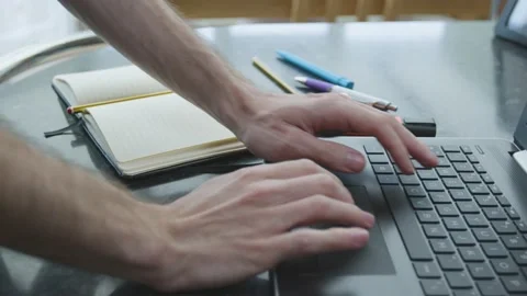 Working from home using a laptop trackpack mouse on kitchen counter with pad Stockbeeldmateriaal 133807490