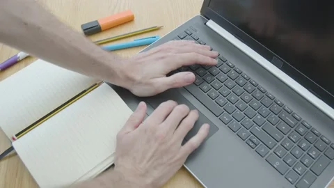 Working from home using a laptop trackpack mouse on the dinner table Stockbeeldmateriaal 133808373