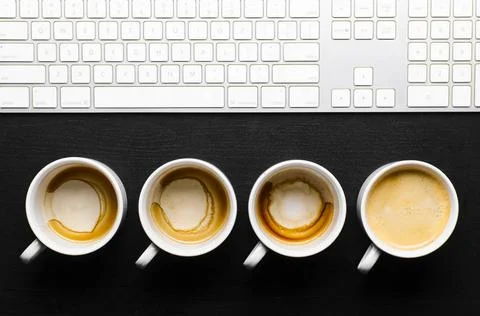Working hours. working hours. empty and full cups of fresh espresso with k... Stock Photos