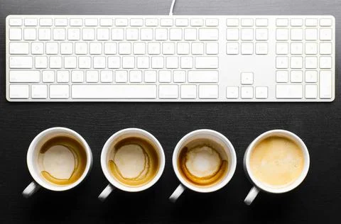 Working hours. working hours. empty and full cups of fresh espresso with k... Stock Photos