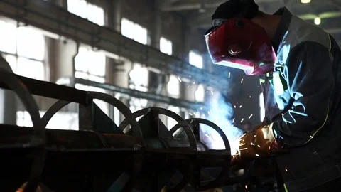 Working in a huge workshop, performing welding work on the chassis high-voltage Stock Footage 71507209