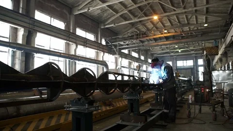 Working in a huge workshop, performing welding work on the chassis high-voltage Stock Footage 71507633