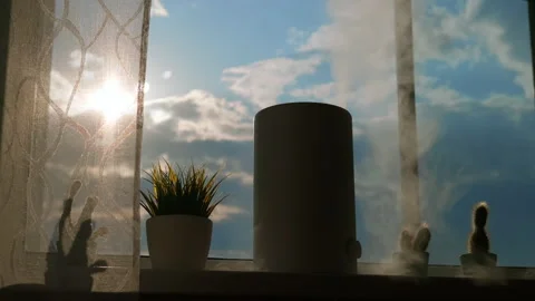 A working humidifier stands on the window while sunlight shines on it. Stock Footage 241406609