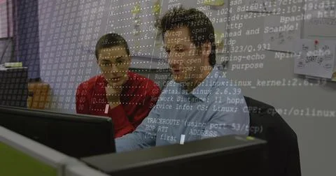 Working IT colleagues reviewing code at desk with terminal overlay, in red 스톡 사진