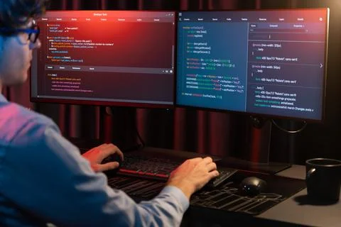 Working IT developer concentrating online software at neon light room. Gusher. 스톡 사진