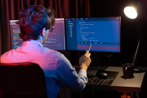 Working IT developer concentrating online software at neon light room. Gusher. 스톡 사진